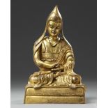 A Chinese gilt bronze figure of a Lama