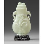 A Chinese pale celadon jade vase and cover