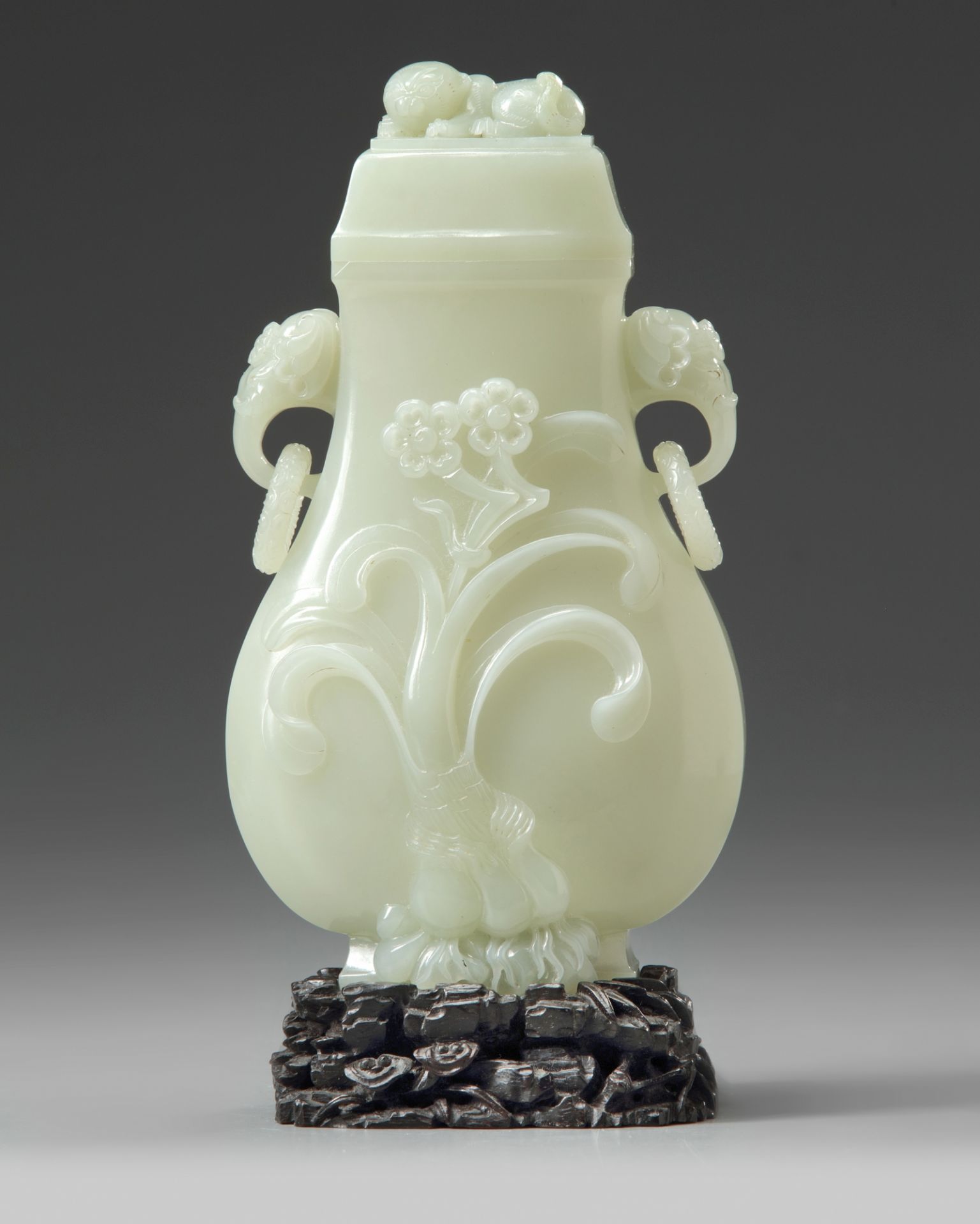 A Chinese pale celadon jade vase and cover