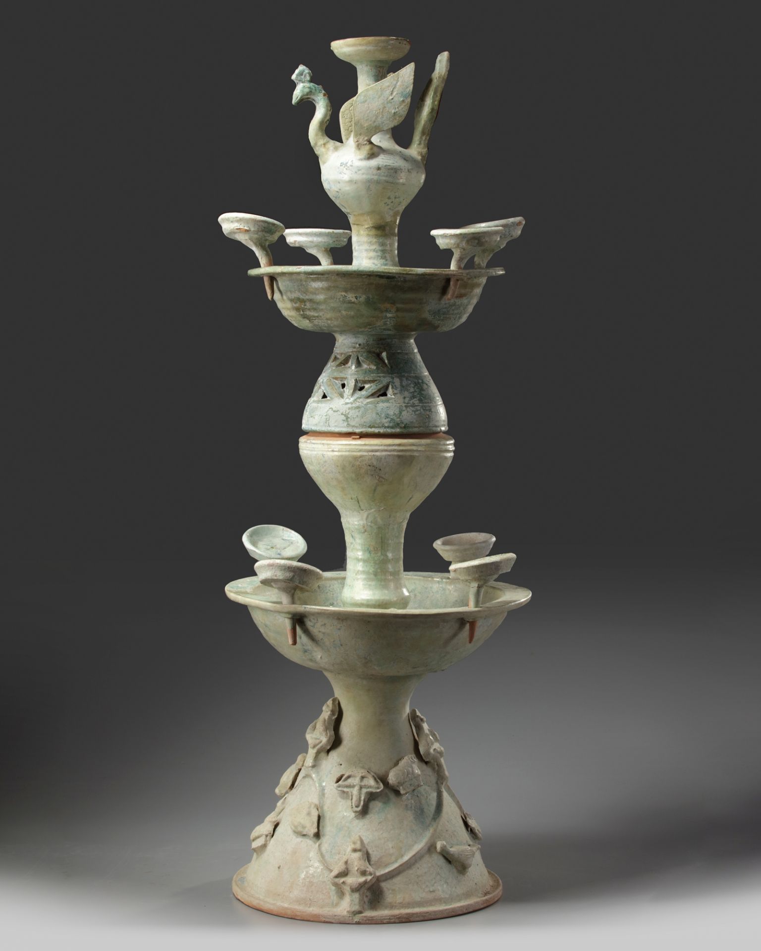 A Chinese green-glazed pottery two-tiered oil lamp