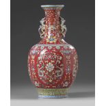 A Chinese red-ground famille rose vase