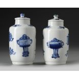 A pair of small Chinese blue and white vases and covers