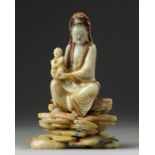 A Chinese soapstone Guanyin figure on stand