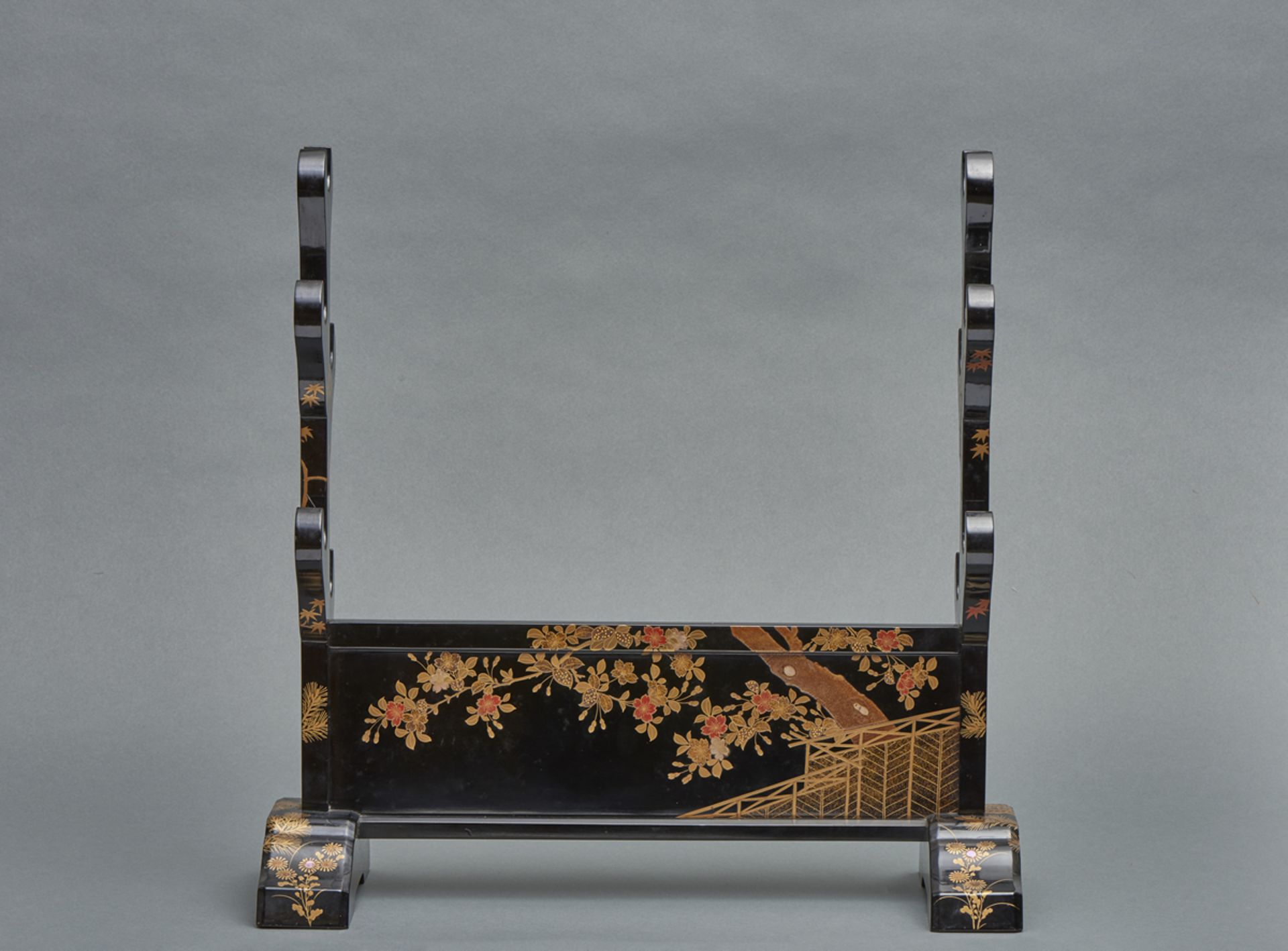 A Japanese black lacquered sword stand (katanakake) for five swords