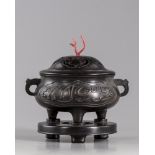 A Chinese bronze censer with wooden stand and cover