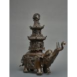 An important Japanese bronze figure of a caparisoned elephant with a pagoda on its back