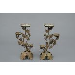 A set of two Japanese bronze candleholders with chrysanthemum leaves and flowers