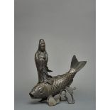 A Japanese bronze figure of bodhisattva Kannon standing on a large carp (koi)