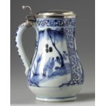 A Japanese blue and white jug with silver cover