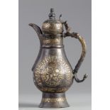 An Islamic silver inlaid copper ewer