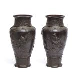 A set of two Japanese bronze vases both decorated with a relief of birds, lotus flowers and trees.