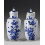 A pair of Chinese blue and white 'floral' vases and covers
