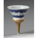 A Chinese café-au-lait glazed blue and white funnel