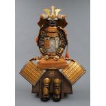 A large gilded Japanese ?yoroi with orange cords (hi’ito odoshi yoroi).