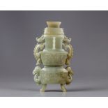 A celadon jade vase with cover