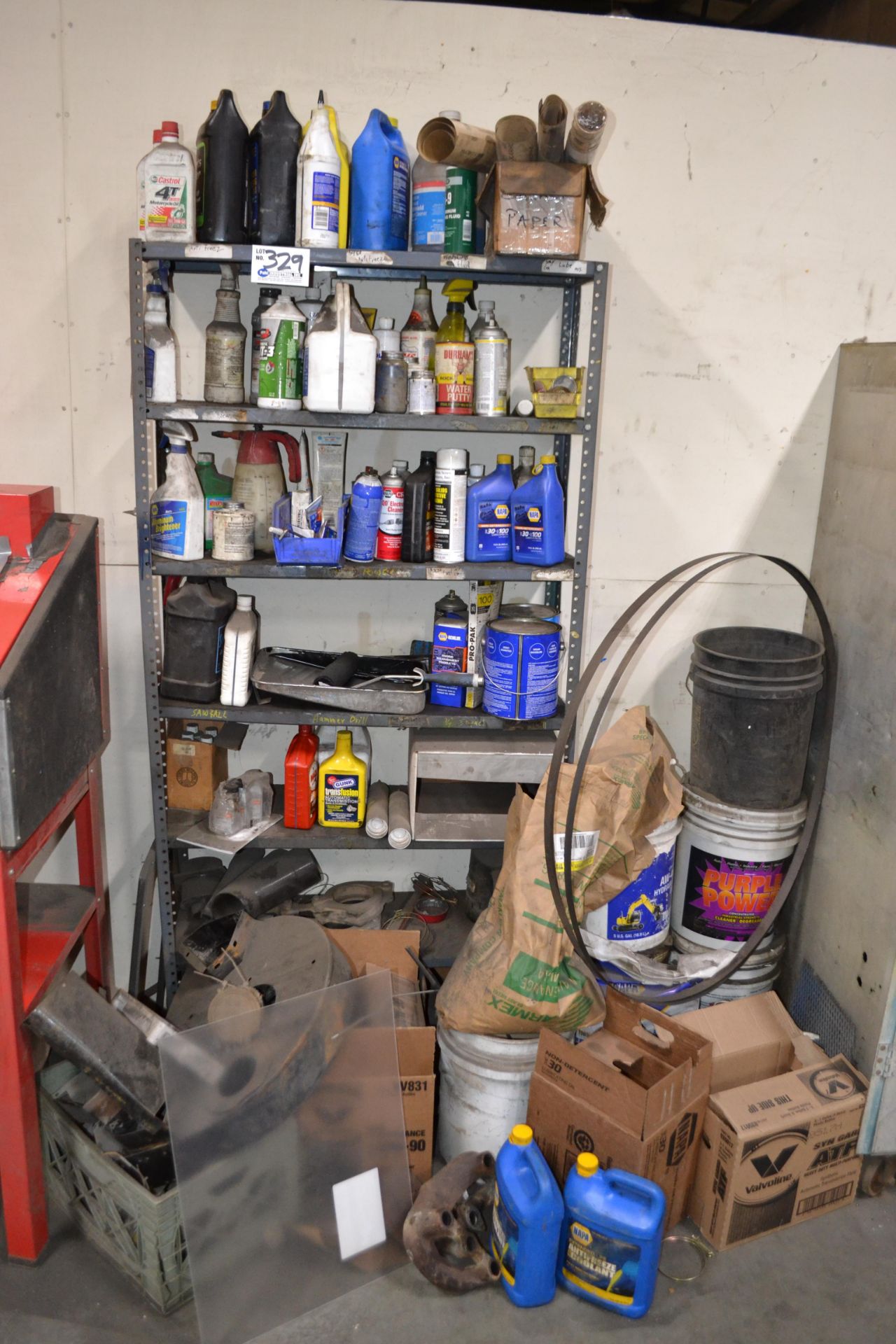 Metal Shelving Unit with assorted oils, cleaners, etc.