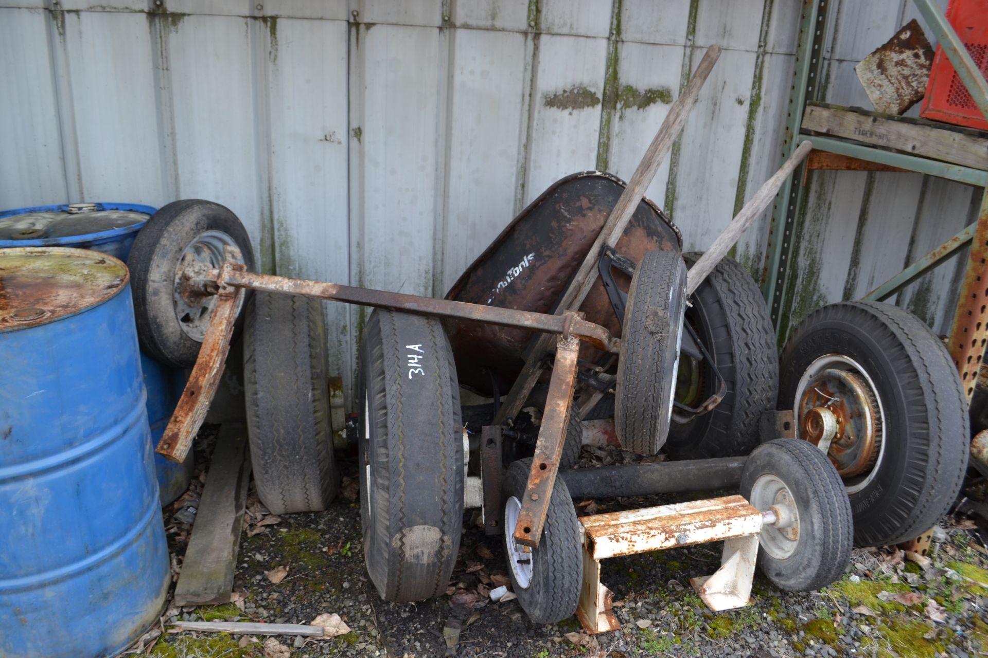 All Remaining contents on wall incl. steel pipe, engines, enclosures, axles, barrels and (2) BBQs