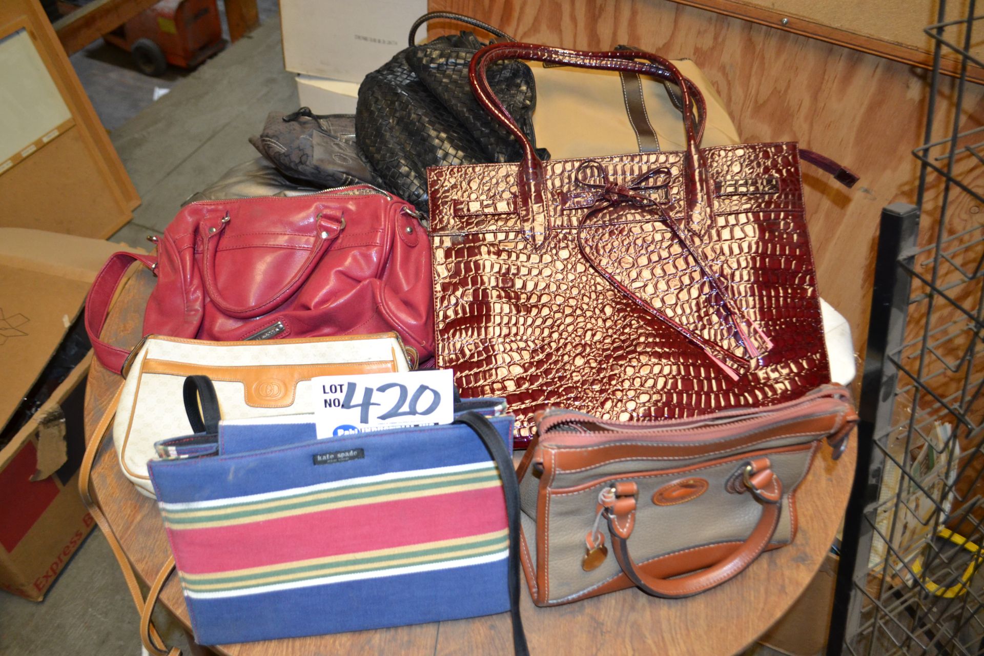 Misc. handbags in mezzanine including Gucci, Kate Spade and Dooney & Bourke