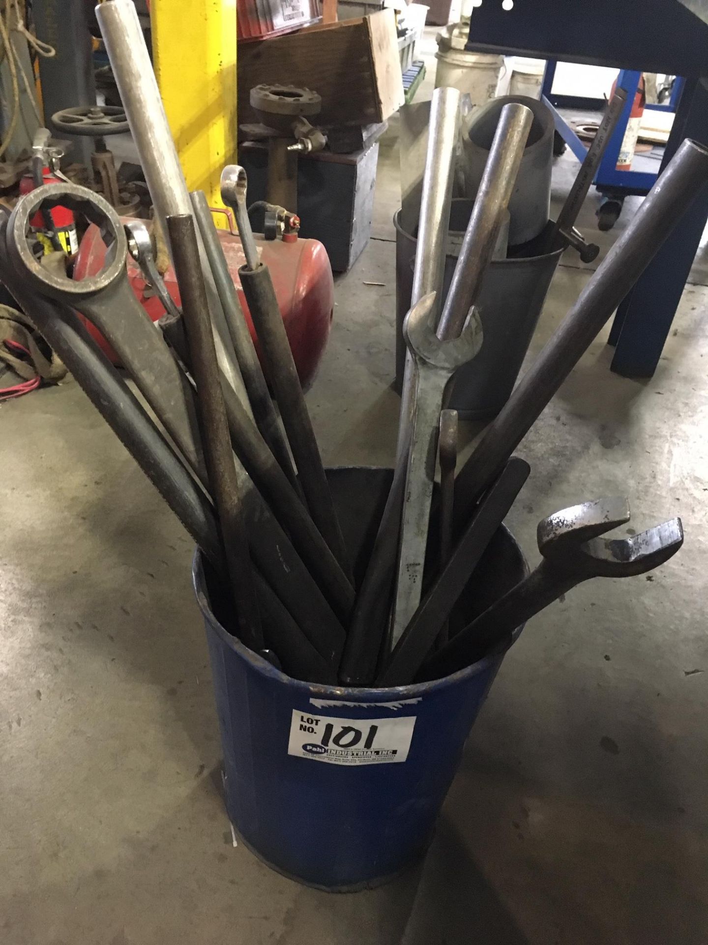 Bucket of assorted box-end wrenches and lever bars