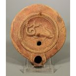 ROMAN POTTERY OIL LAMP WITH SWIMMING DOLPHIN