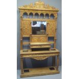 LATE VICTORIAN PALE OAK MIRROR BACKED HALL STAND having arcaded frieze under a moulded and carved