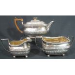 GEORGE III THREE PIECE SILVER TEA SERVICE of oval fluted form with wicker banding and egg and dart