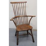 19TH CENTURY PRIMITIVE COMB AND STICK BACKED FIRESIDE ELBOW CHAIR with moulded saddle seat on