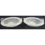 PAIR OF BELLEEK IRISH PORCELAIN TWIN HANDLED PEDESTAL BOWLS overall with pierced lattice decoration,