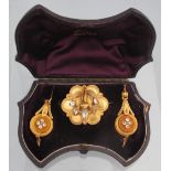 A VICTORIAN DEMI PARURE OF BLOOMED GOLD BROOCH and pendant earrings set with foiled paste stones.