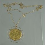 A 1915 GEORGE V GOLD SOVEREIGN set in 9ct gold scrolling mount on a 61cm gold chain.