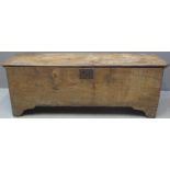 17TH/EARLY 18TH CENTURY ELM PLANK CHEST having wire hinges to the moulded edge top and plain