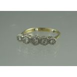 18CT GOLD PLATINUM MOUNTED FIVE STONE DIAMOND RING.