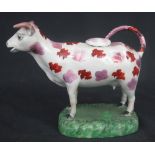 19TH CENTURY SWANSEA PEARLWARE POTTERY COW CREAMER splash decorated with brown and pink lustres on