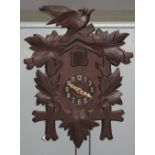 THREE SIMILAR BAVARIAN CARVED AND STAINED WOODEN AUTOMATON CUCKOO CLOCKS cases all with bird