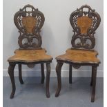 PAIR OF LATE 19TH CENTURY SWISS OR BAVARIAN HALL CHAIRS decorated with reserve panels of ibex,