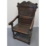 17TH CENTURY OAK WAINSCOT TYPE ELBOW CHAIR with scrolled cresting over lozenge moulded panel,
