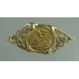 A GEORGE V 1911 GOLD HLAF SOVEREIGN set in 9ct gold scrolling foliate brooch mount. 2 x 5cm approx.