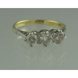 18CT GOLD THREE STONE DIAMOND RING.