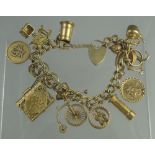 9CT GOLD CHARM BRACELET with heart shaped padlock clasp and fourteen charms. Length 7", weight 45.