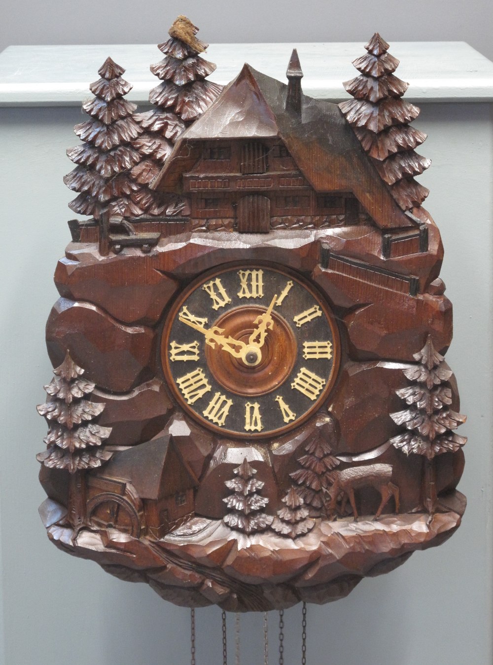 LATE 19TH CENTURY BAVARIAN CARVED AND STAINED WOODEN AUTOMATON CUCKOO CLOCK the case in the form of