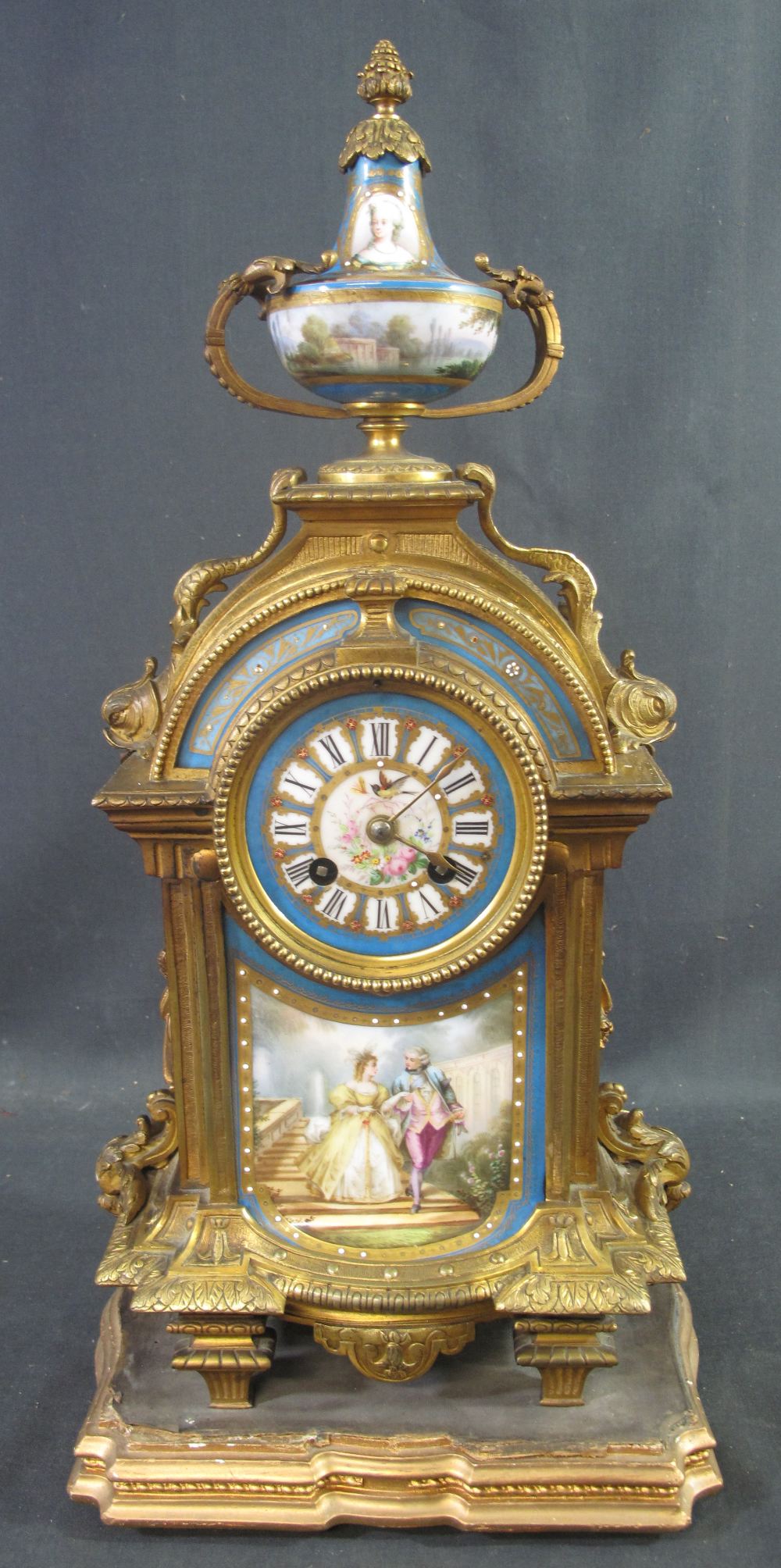 19TH CENTURY ORMOLU PORCELAIN MOUNTED TWO TRAIN MANTEL CLOCK the case with urn shaped porcelain