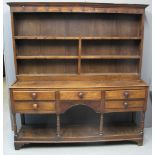 EARLY 19TH CENTURY WELSH OAK POTBOARD DRESSER having reduced rack with moulded cornice over two