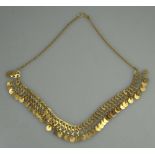 UNMARKED YELLOW METAL FRINGE NECKLACE. Plain gold discs hanging from fancy gold links on curb chain.