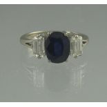 AN 18CT WHITE GOLD THREE STONE SAPPHIRE AND DIAMOND RING.