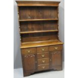 SMALL RECONSTRUCTED WELSH OAK DRESSER having two shelf boarded rackback over projecting base with