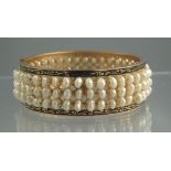 HINGED TRIPLE ROW PEARL BANGLE.