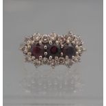 18CT GOLD RUBY AND DIAMOND TRIPLE CLUSTER RING.