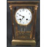 EARLY 20TH CENTURY FRENCH GILT BRASS FOUR GLASS PRESENTATION MANTEL CLOCK having circular Arabic