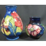 TWO MID 20TH CENTURY MOORCROFT ART POTTERY TUBE LINED VASES of baluster form,