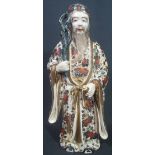 JAPANESE MEIJI SATSUMA FIGURE OF 'JUROJIN' standing with his staff and holding a scroll in floral